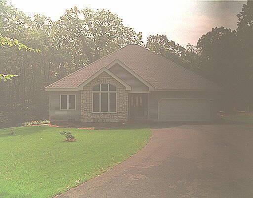 a front view of a house with a garden and yard