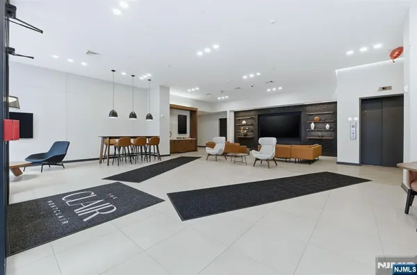 a living room with furniture and a dining table with wooden floor