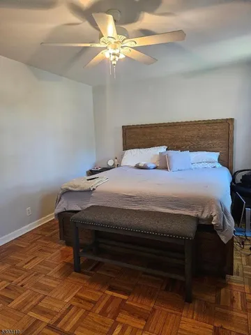 a bedroom with a bed and a ceiling fan