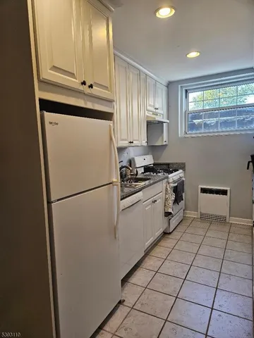 a white refrigerator freezer and a stove in a kitchen