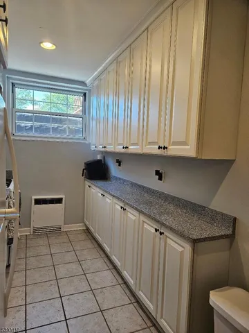 a kitchen with stainless steel appliances a sink window and cabinets