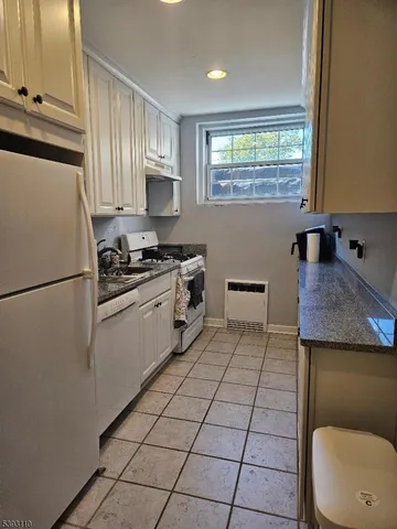 a kitchen with a cabinets and white appliances