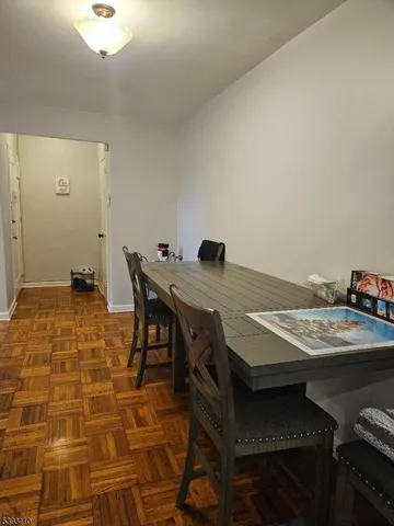 a dining room with a table and chairs