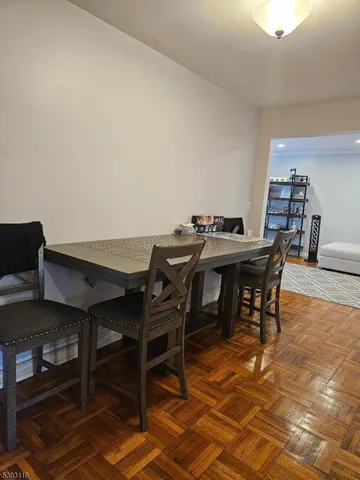 a view of a dining hall with furniture and wooden floor