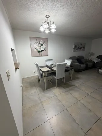 a view of a livingroom with furniture and a chandelier fan