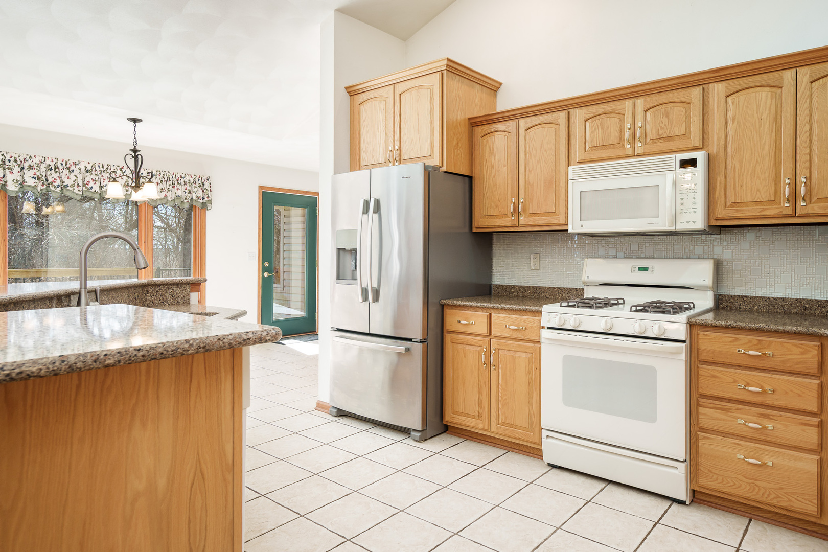 261 West Redtail Lane Oregon, IL 61061 - Photo 17 of 63 a kitchen with granite countertop cabinets and steel stainless steel appliances