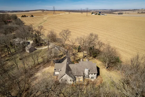 a view of a kitchen with furniture a fireplace and wooden floor