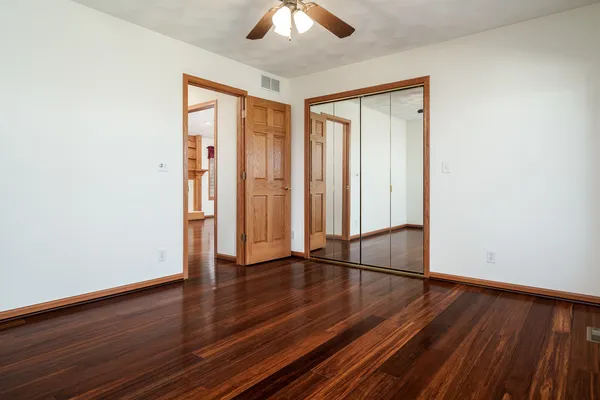 a view of staircase with railing and white walls