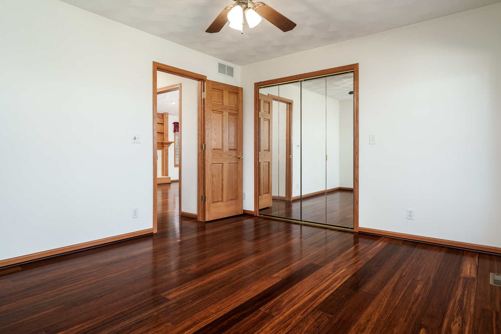 261 West Redtail Lane Oregon, IL 61061 - Photo 34 of 63 an empty room with wooden floor chandelier fan and windows
