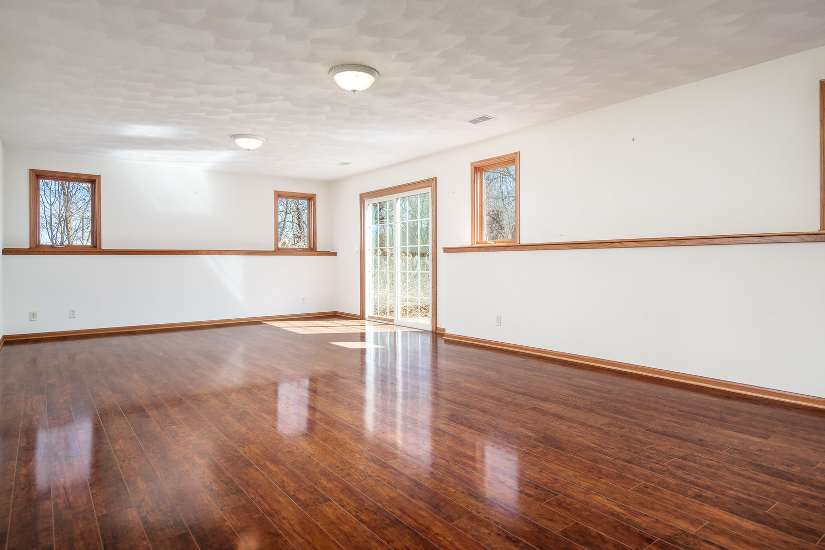261 West Redtail Lane Oregon, IL 61061 - Photo 42 of 63 a view of an empty room with wooden floor and a window