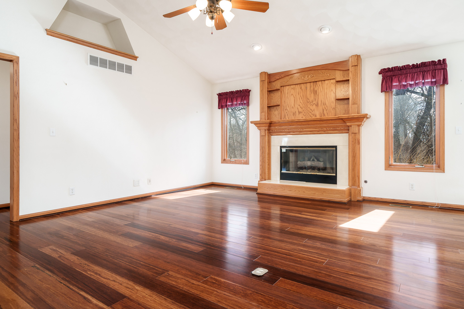 261 West Redtail Lane Oregon, IL 61061 - Photo 7 of 63 a view of an empty room with wooden floor fireplace and a window