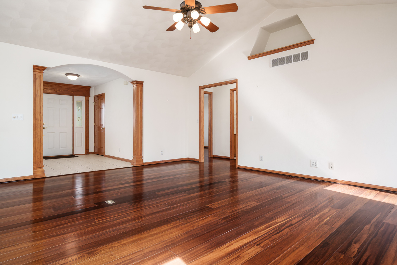 261 West Redtail Lane Oregon, IL 61061 - Photo 9 of 63 a view of an empty room with wooden floor and a chandelier