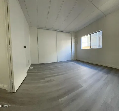 a spacious bathroom with a double vanity sink a mirror and a toilet