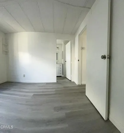 a living room with furniture a window and wooden floor