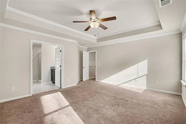 a view of a big room with closet and ceiling fan