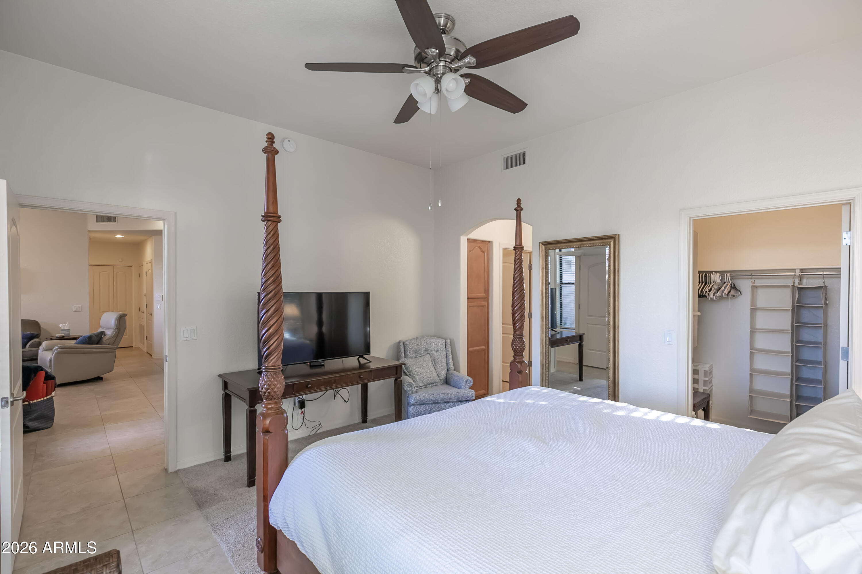 7027 North Scottsdale Road, Unit 132 Paradise Valley, AZ 85253 - Photo 11 of 48 a bedroom with a bed and a flat tv screen on dresser