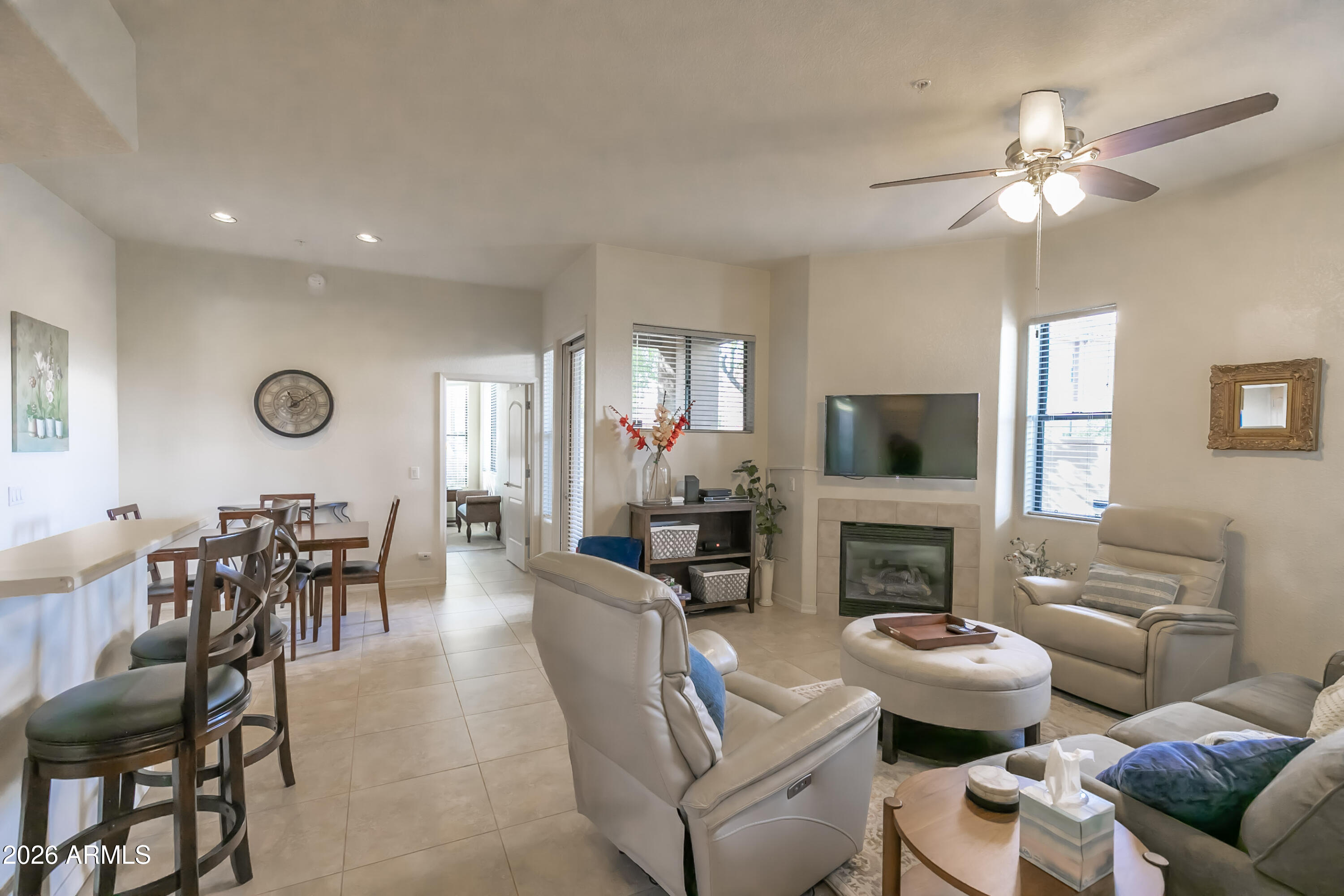7027 North Scottsdale Road, Unit 132 Paradise Valley, AZ 85253 - Photo 2 of 48 a living room with furniture a fireplace and a flat screen tv