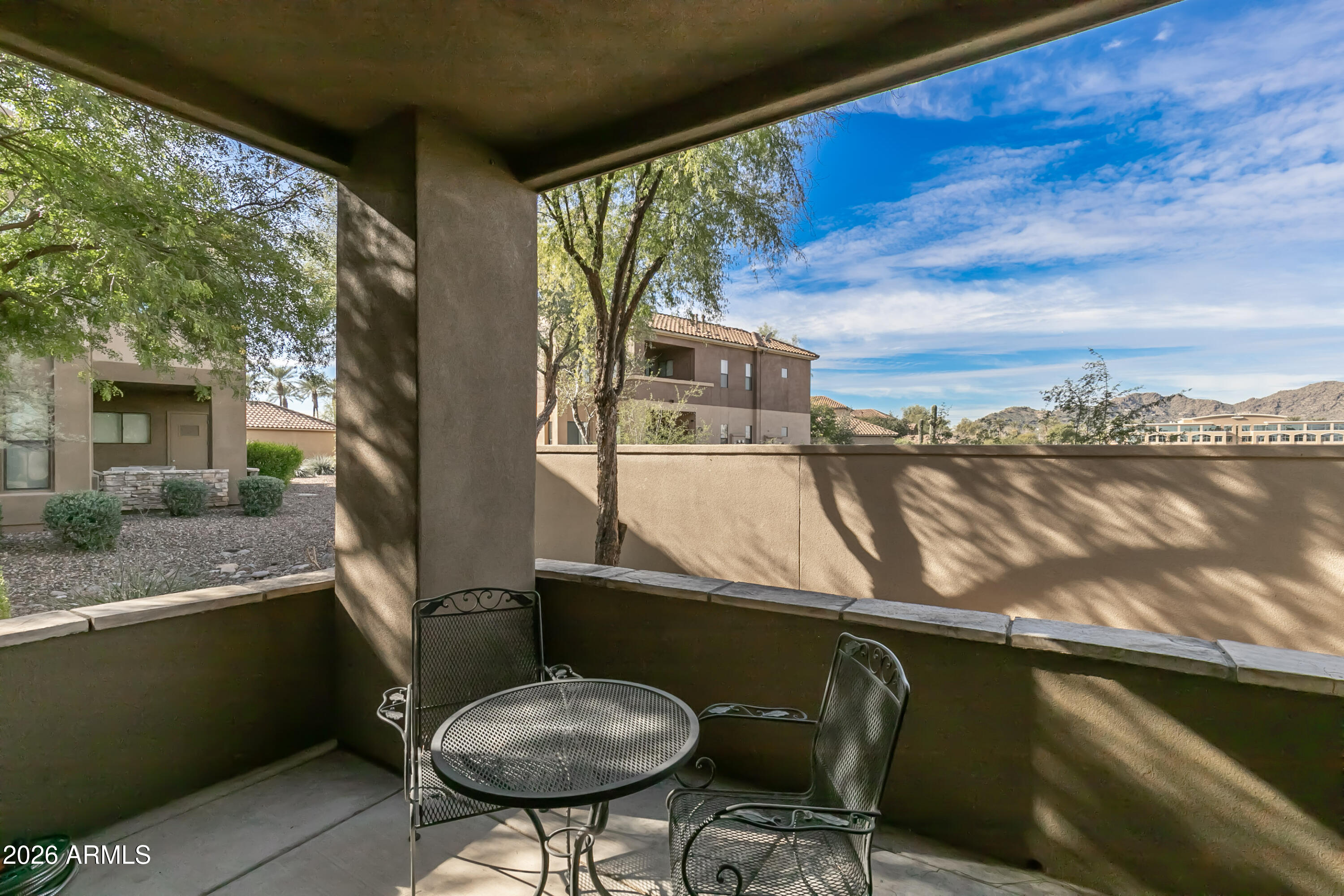 7027 North Scottsdale Road, Unit 132 Paradise Valley, AZ 85253 - Photo 30 of 48 a balcony with table and chairs
