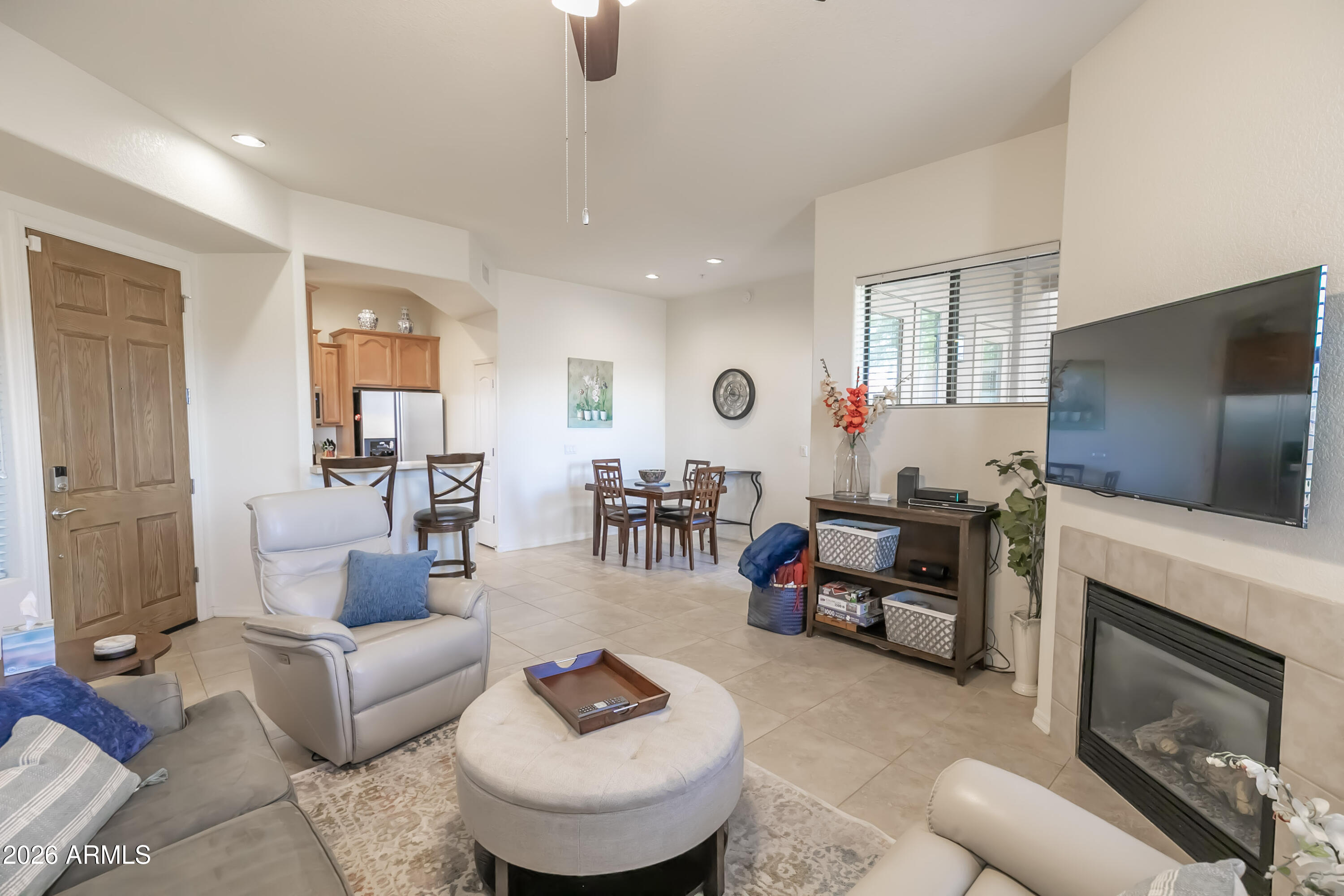 7027 North Scottsdale Road, Unit 132 Paradise Valley, AZ 85253 - Photo 3 of 48 a living room with furniture a fireplace and a flat screen tv