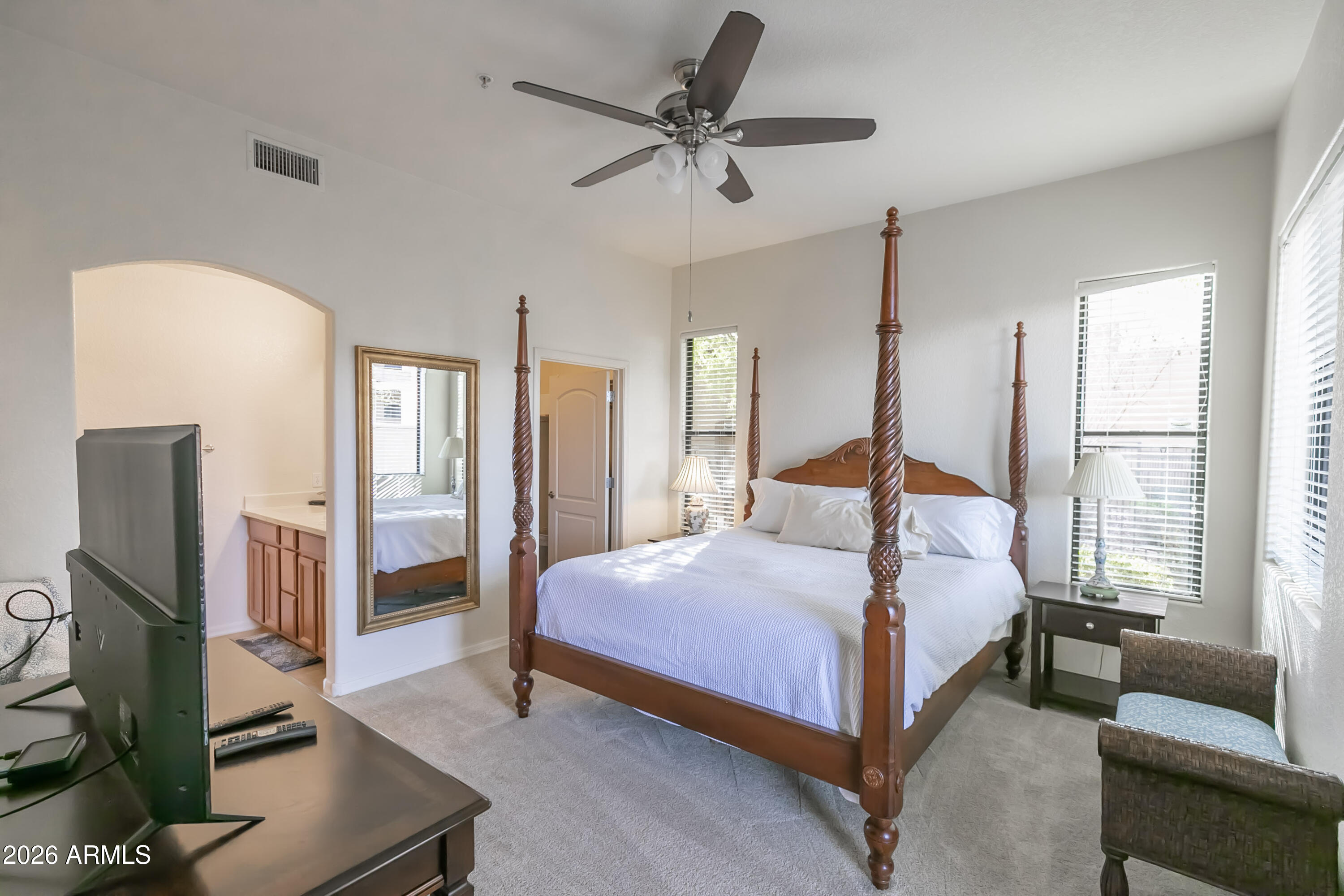 7027 North Scottsdale Road, Unit 132 Paradise Valley, AZ 85253 - Photo 9 of 48 a bedroom with a bed and a flat screen tv