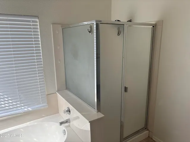 a bathroom with a bathtub and a shower