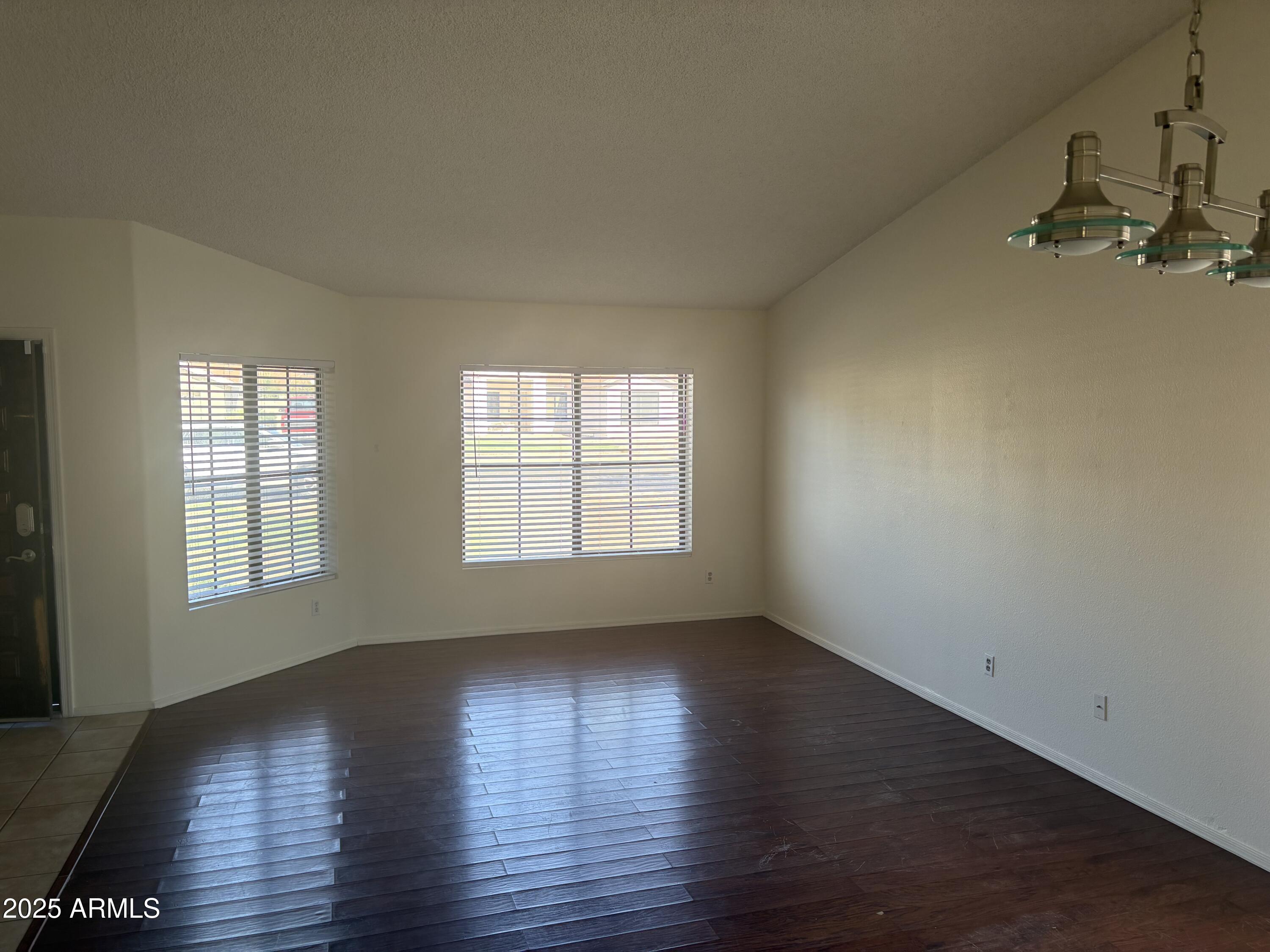 4661 West Whitten Street Chandler, AZ 85226 - Photo 7 of 17 an empty room with wooden floor and windows
