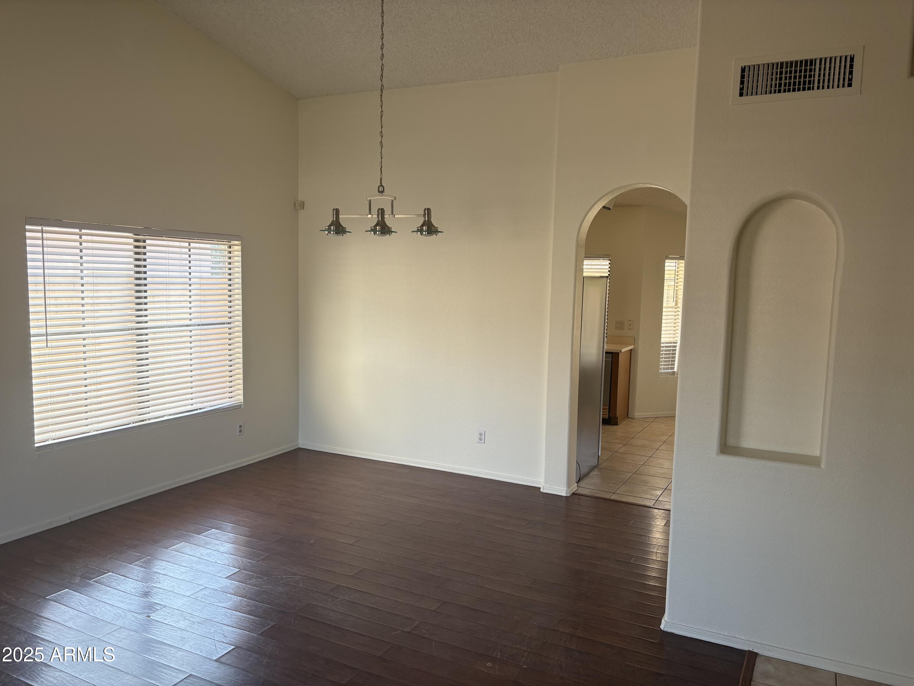 4661 West Whitten Street Chandler, AZ 85226 - Photo 8 of 17 an empty room with wooden floor and windows