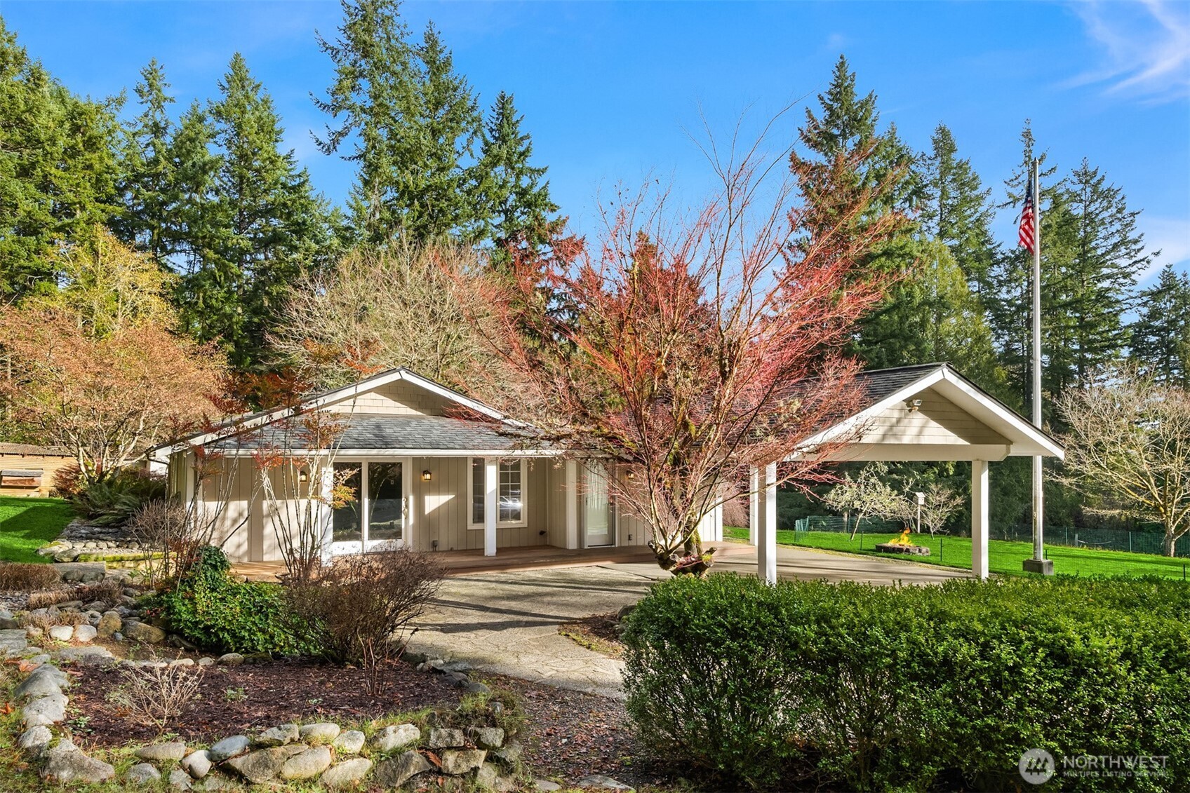 12620 Old Military Road Northeast Poulsbo, WA 98370 - Photo 1 of 35 a front view of a house with yard and green space