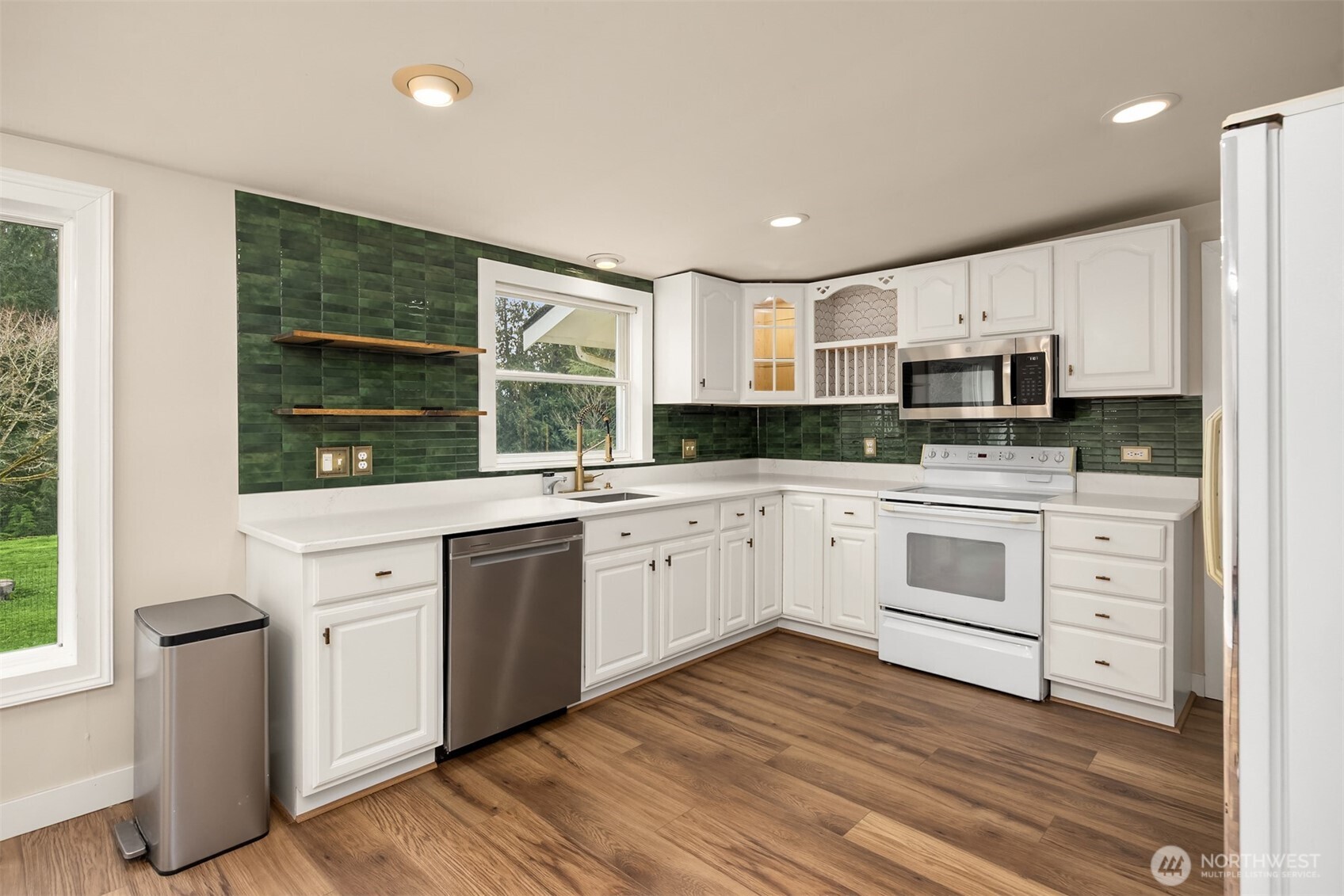 12620 Old Military Road Northeast Poulsbo, WA 98370 - Photo 12 of 35 a kitchen with granite countertop white cabinets and white appliances