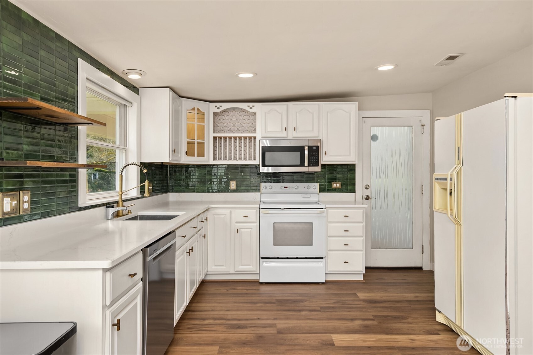 12620 Old Military Road Northeast Poulsbo, WA 98370 - Photo 13 of 35 a kitchen with white cabinets and stainless steel appliances