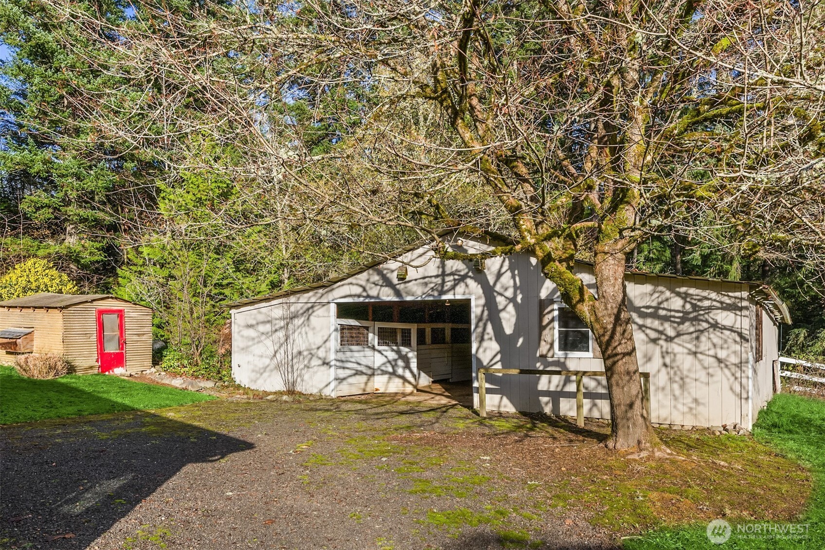 12620 Old Military Road Northeast Poulsbo, WA 98370 - Photo 19 of 35 a view of a garage with a tree