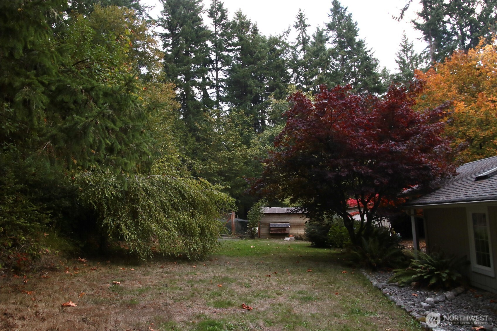 12620 Old Military Road Northeast Poulsbo, WA 98370 - Photo 23 of 35 a view of a house with a tree