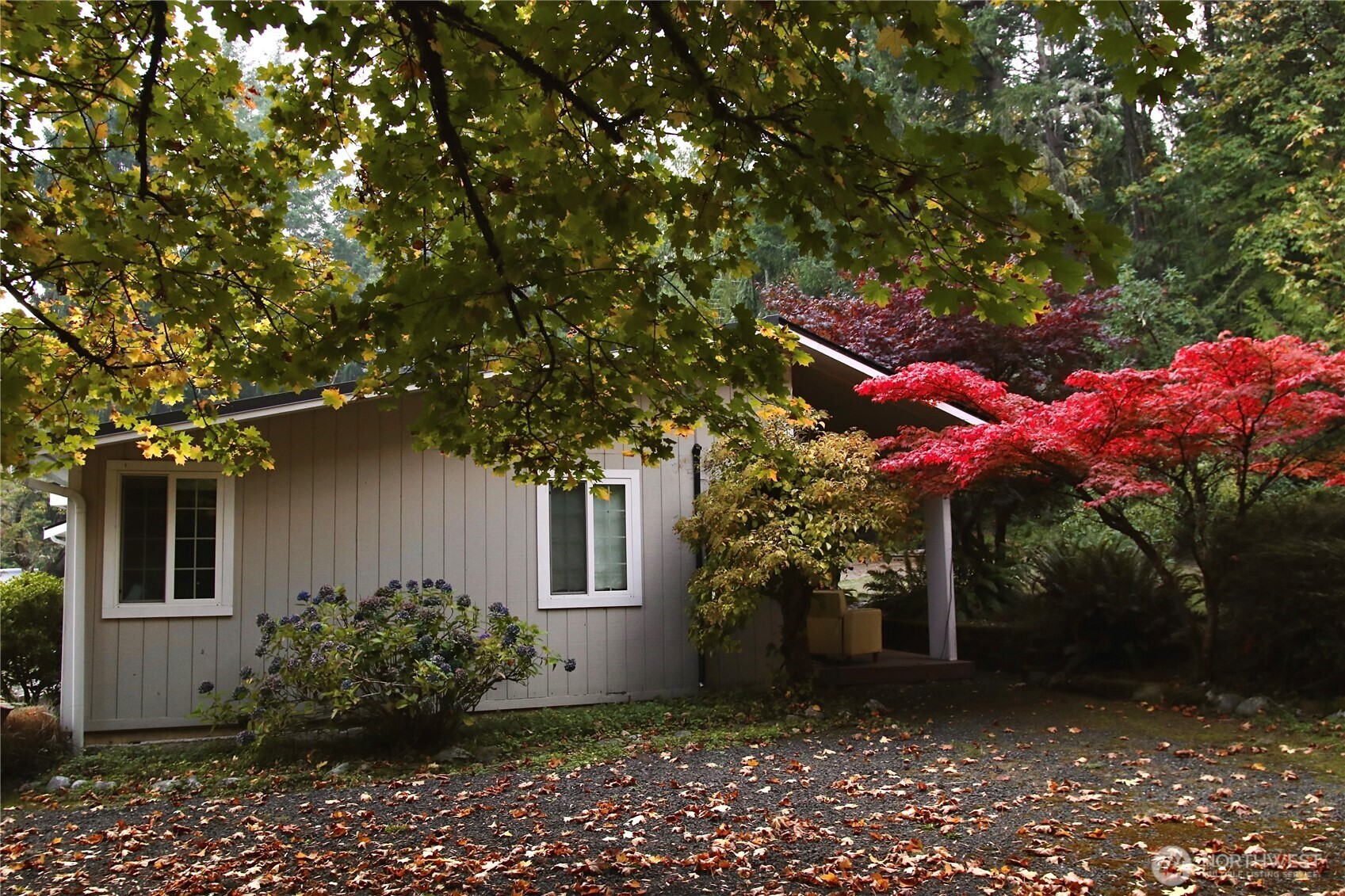 12620 Old Military Road Northeast Poulsbo, WA 98370 - Photo 26 of 35 a front view of a house with a yard