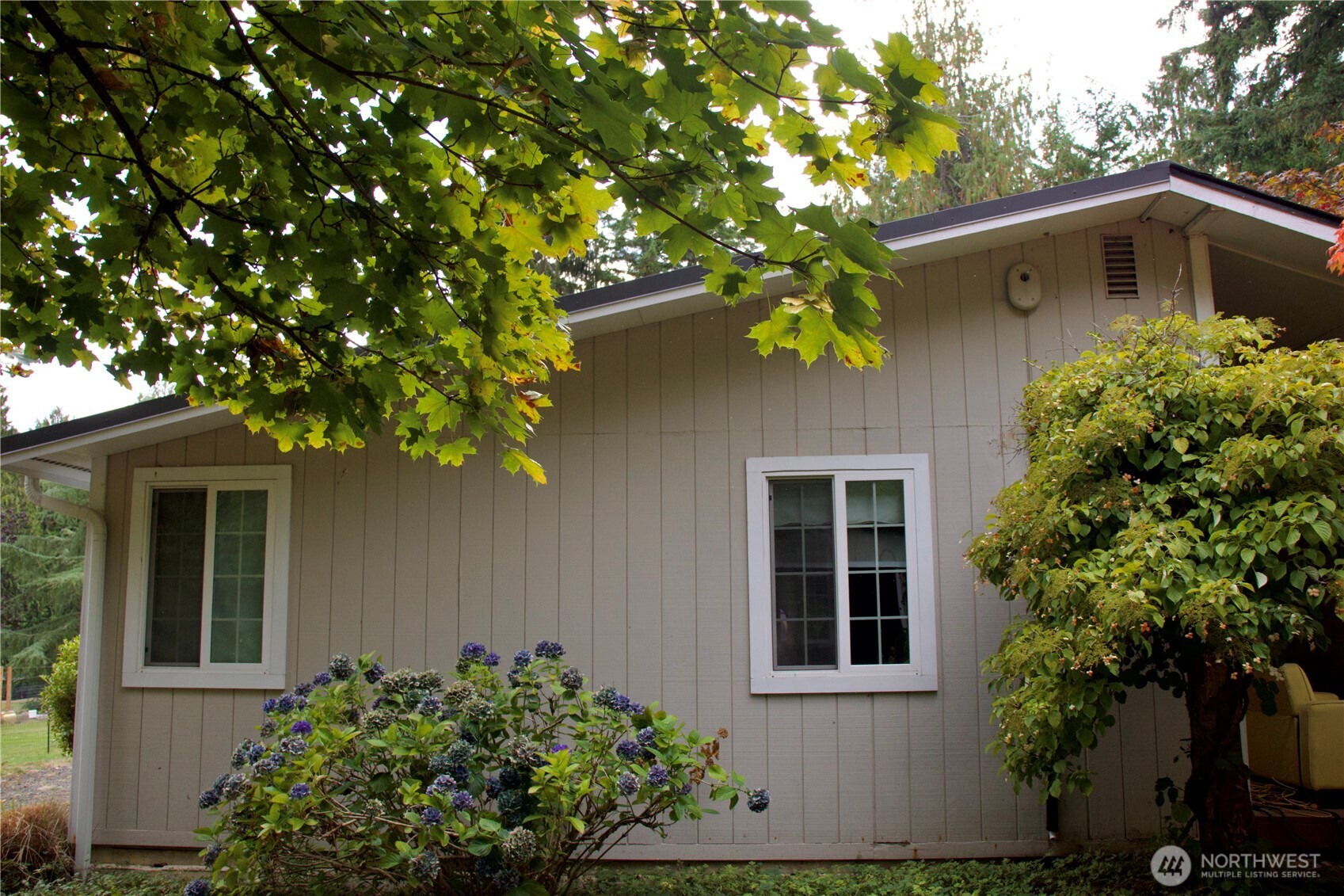 12620 Old Military Road Northeast Poulsbo, WA 98370 - Photo 27 of 35 a front view of a house with a yard