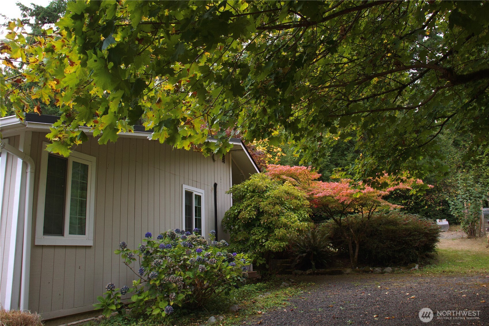 12620 Old Military Road Northeast Poulsbo, WA 98370 - Photo 28 of 35 front view of a house with a tree