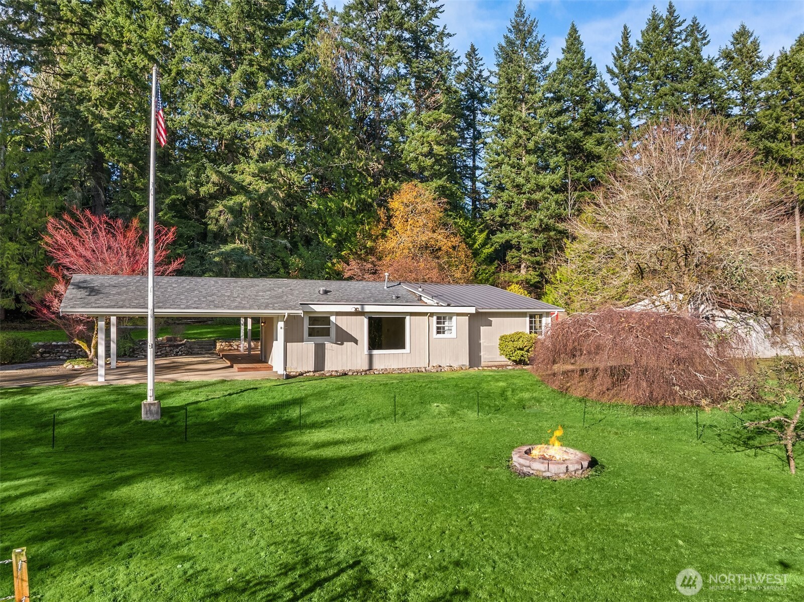 12620 Old Military Road Northeast Poulsbo, WA 98370 - Photo 5 of 35 a front view of a house with garden