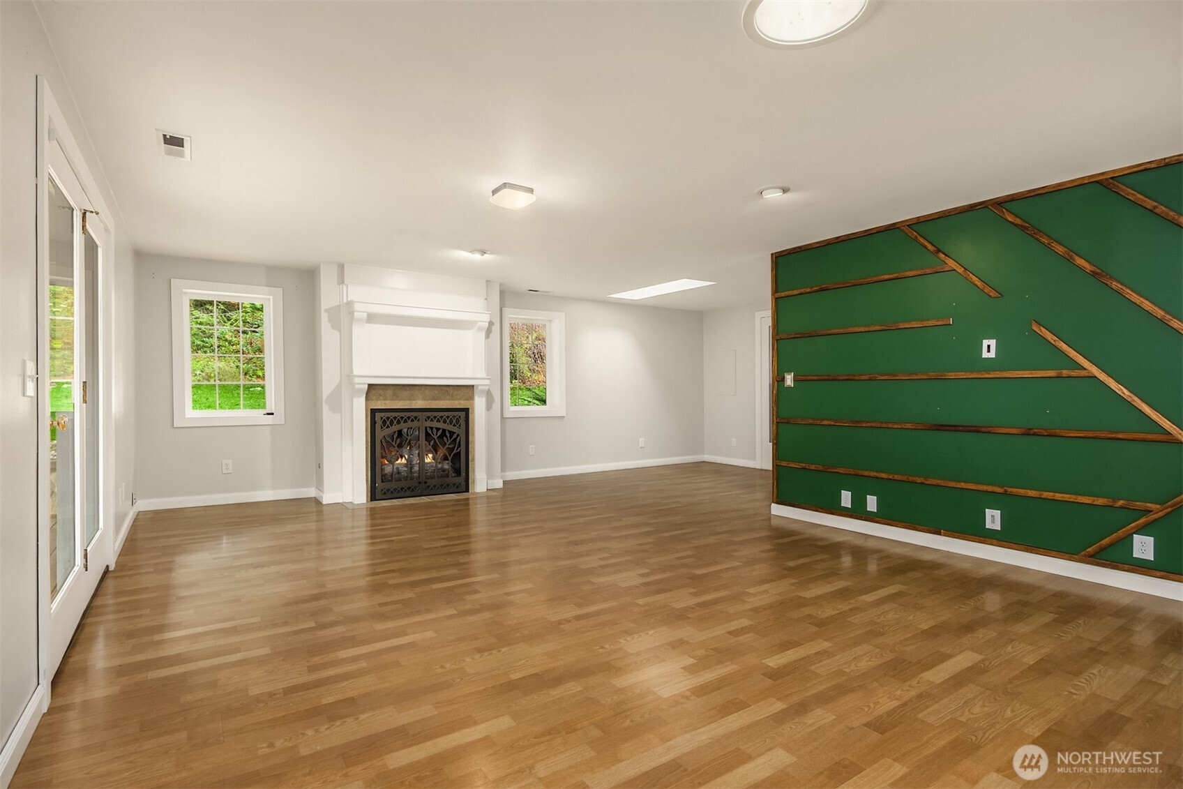 12620 Old Military Road Northeast Poulsbo, WA 98370 - Photo 9 of 35 a view of an empty room with a fireplace and a window