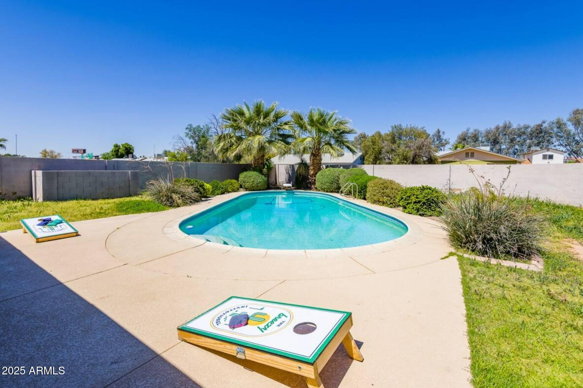 a view of a swimming pool with a yard