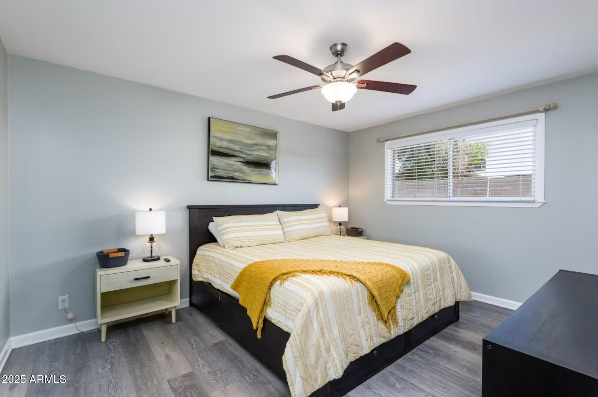 1612 West Geneva Drive Tempe, AZ 85282 - Photo 12 of 36 a bedroom with a bed a window and a chandelier