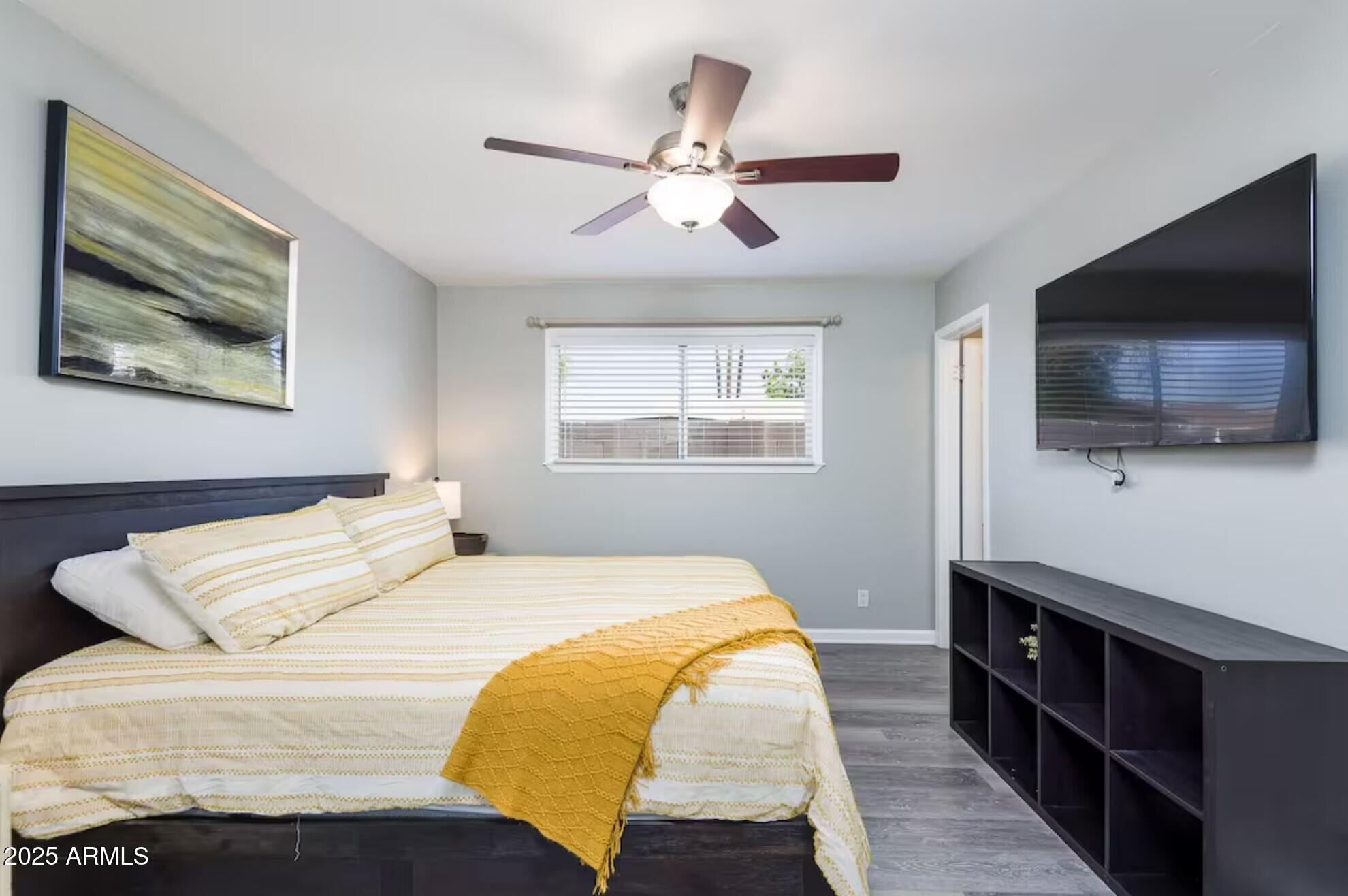 1612 West Geneva Drive Tempe, AZ 85282 - Photo 13 of 36 a bedroom with a bed and a flat screen tv