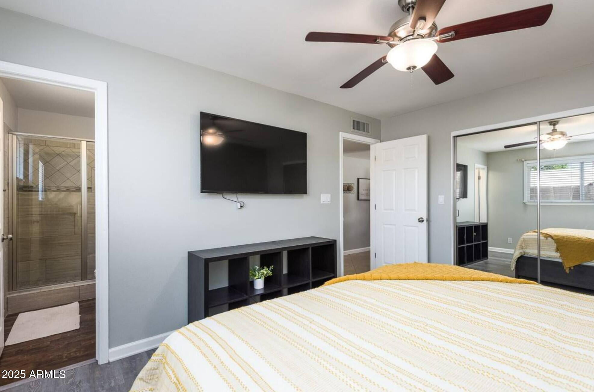 1612 West Geneva Drive Tempe, AZ 85282 - Photo 15 of 36 a bedroom with a bed and a flat screen tv