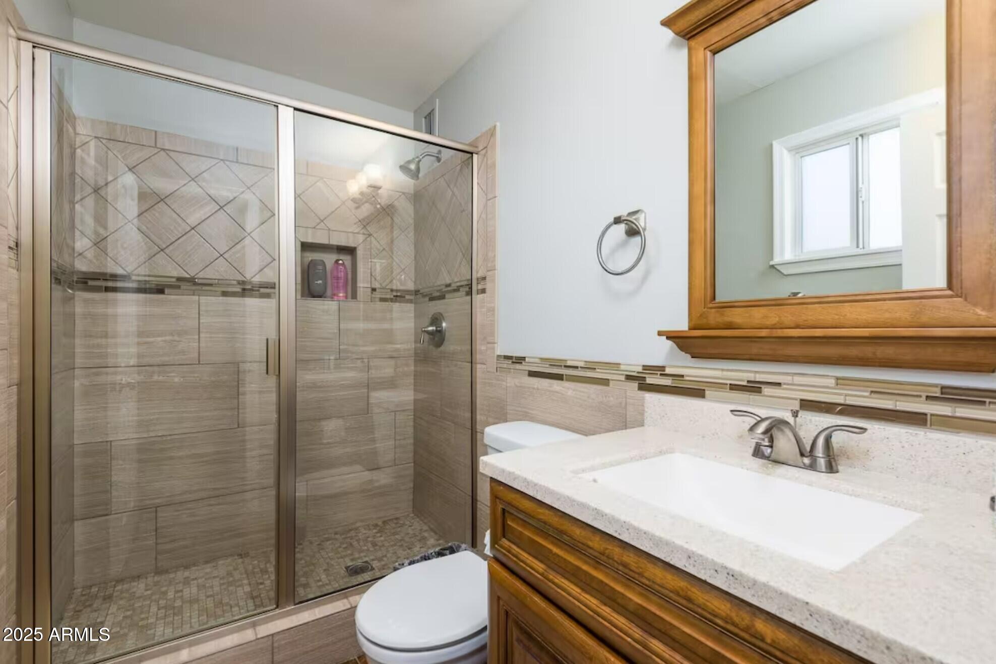 1612 West Geneva Drive Tempe, AZ 85282 - Photo 16 of 36 a bathroom with a sink a toilet and shower