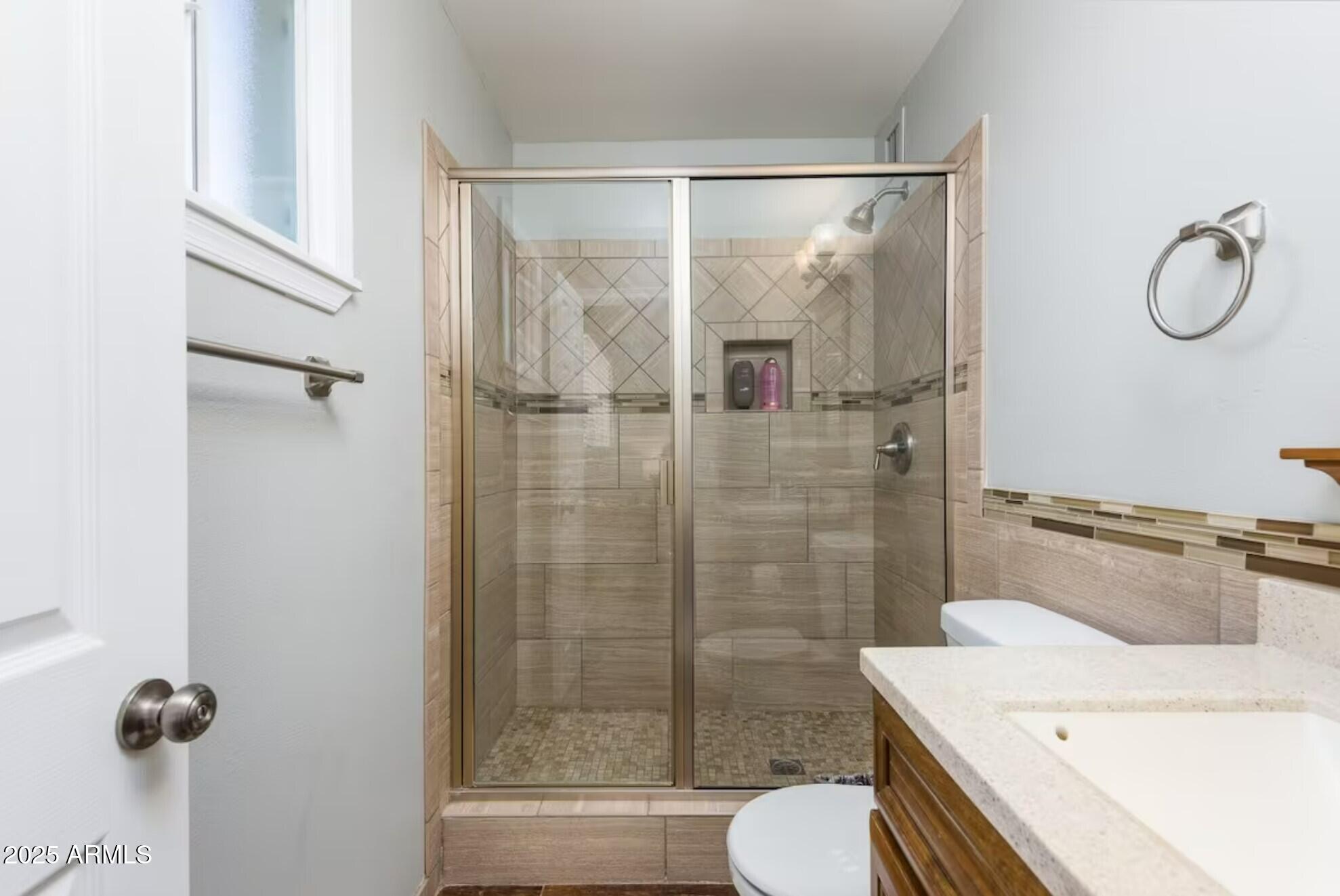 1612 West Geneva Drive Tempe, AZ 85282 - Photo 17 of 36 a bathroom with a granite countertop sink toilet and shower
