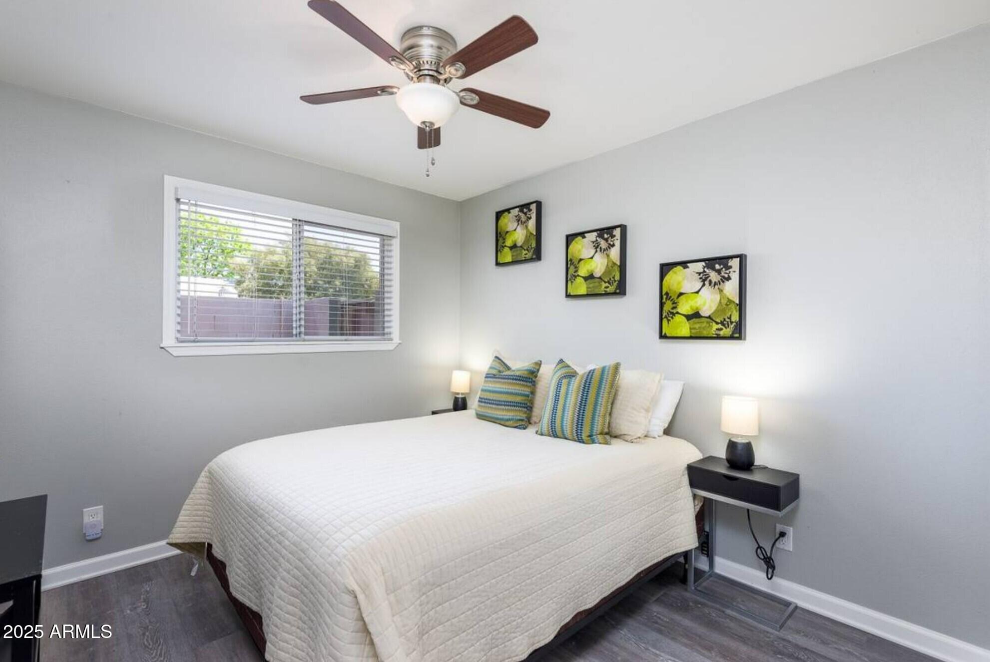 1612 West Geneva Drive Tempe, AZ 85282 - Photo 18 of 36 a bedroom with a bed and a lamp on dresser