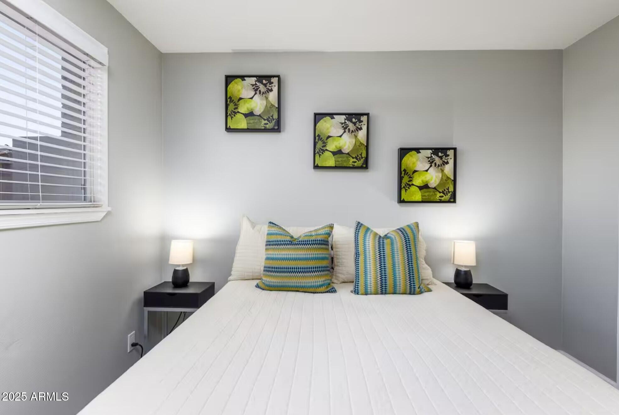 1612 West Geneva Drive Tempe, AZ 85282 - Photo 19 of 36 a bedroom with a bed and painting on the wall