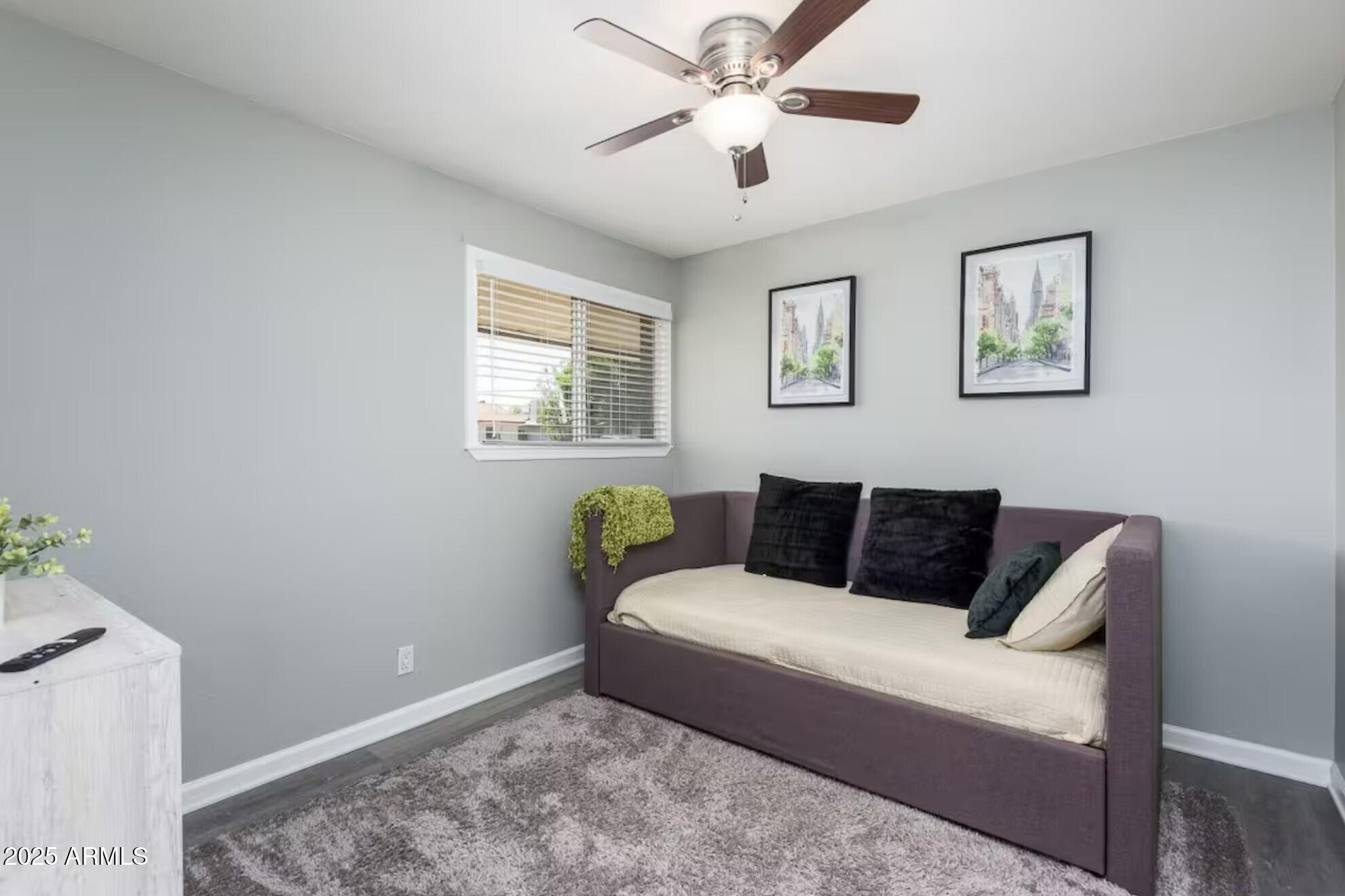 1612 West Geneva Drive Tempe, AZ 85282 - Photo 22 of 36 a bed sitting in a bedroom next to a window with a chandelier