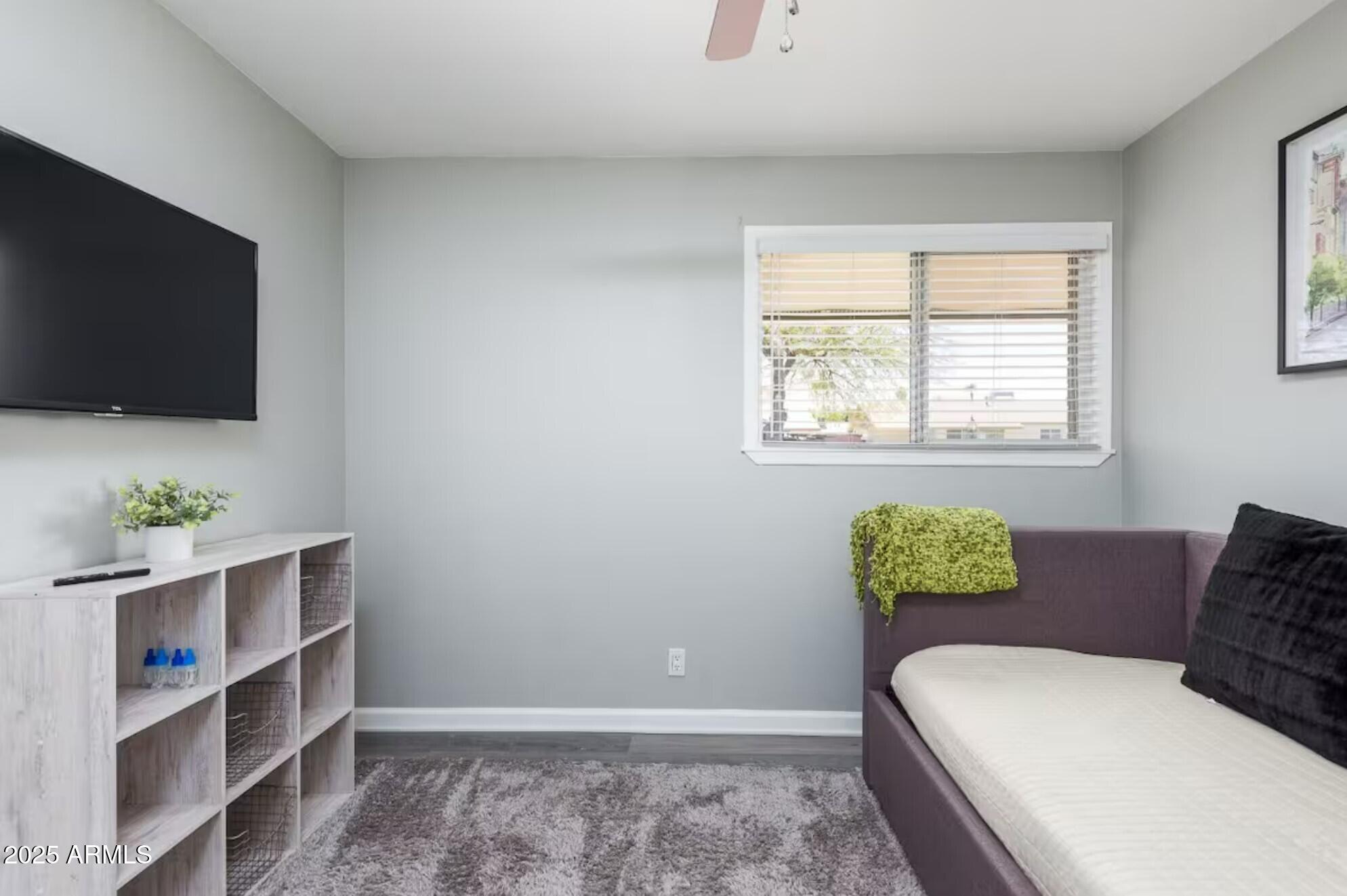 1612 West Geneva Drive Tempe, AZ 85282 - Photo 24 of 36 a room with a bed and a flat screen tv