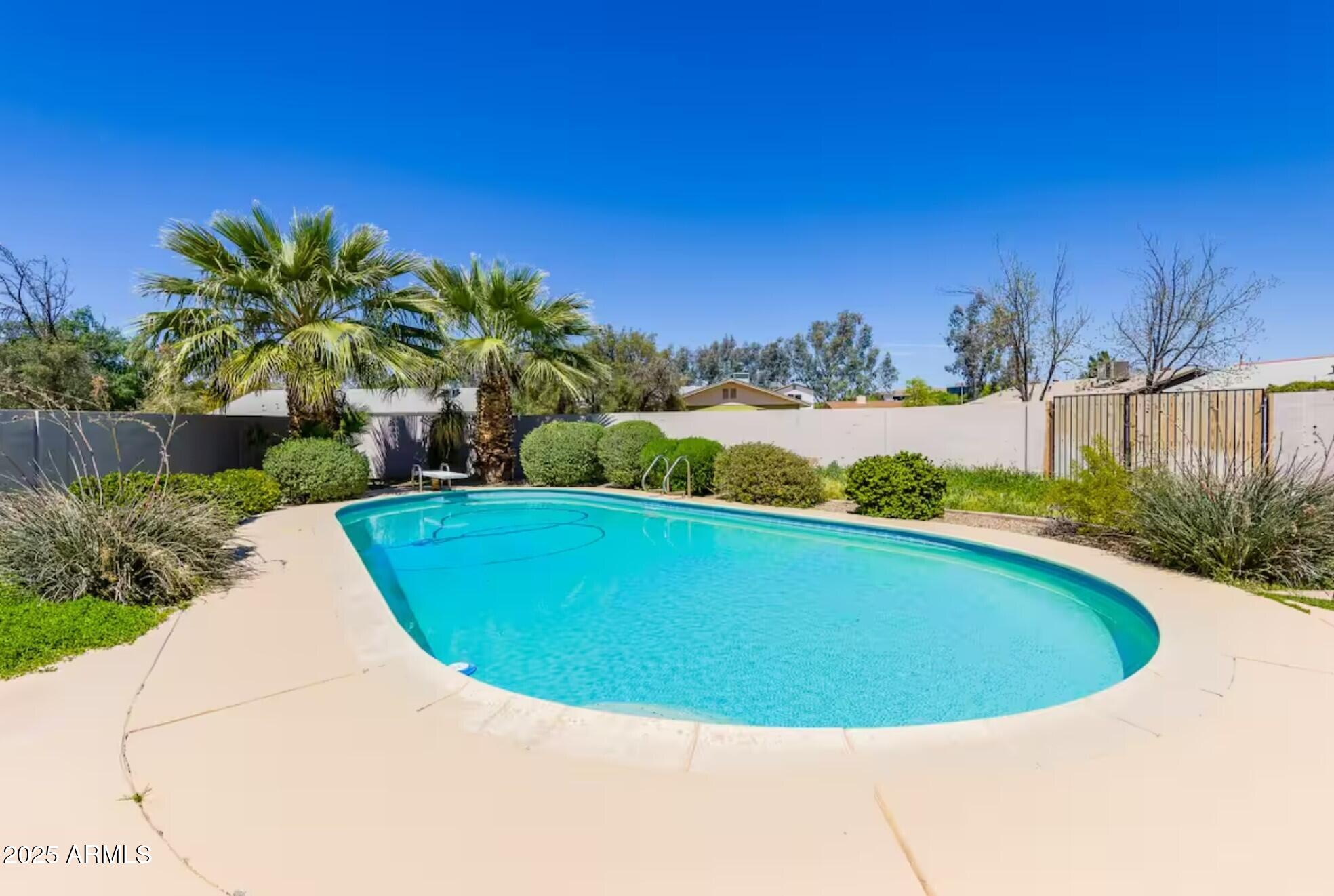 1612 West Geneva Drive Tempe, AZ 85282 - Photo 29 of 36 a view of a swimming pool in the backyard of a house