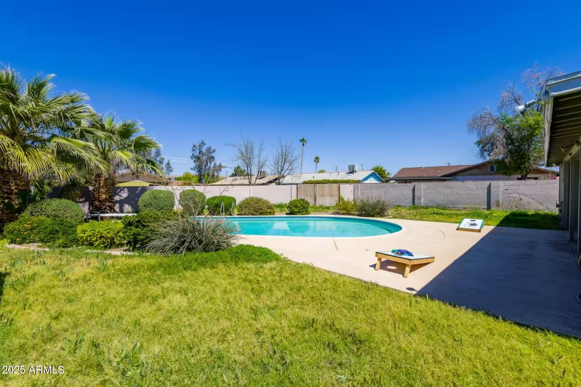 1612 West Geneva Drive Tempe, AZ 85282 - Photo 33 of 36 a view of a backyard with table and chairs under an umbrella