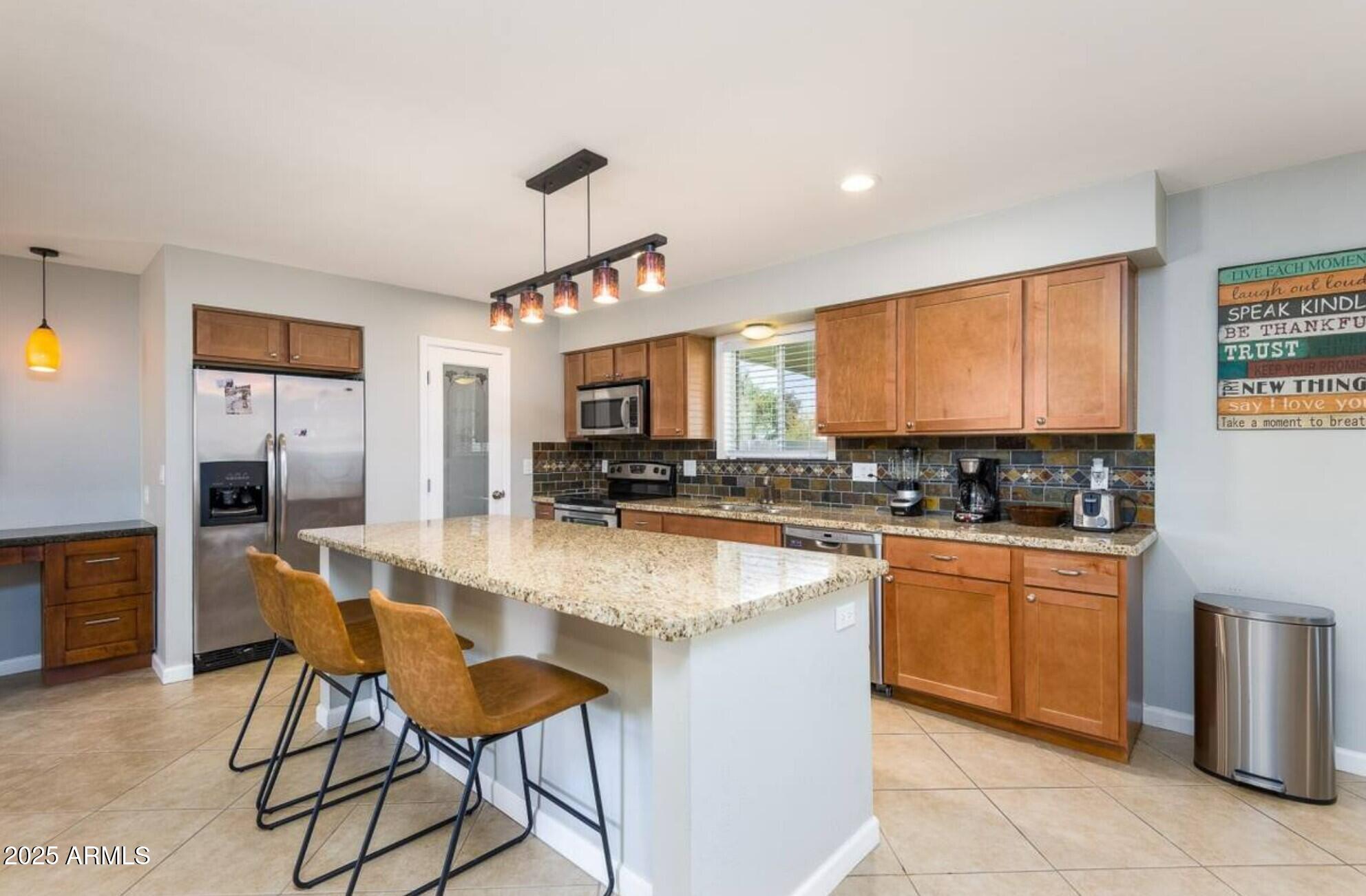 1612 West Geneva Drive Tempe, AZ 85282 - Photo 8 of 36 a large kitchen with kitchen island a large counter top space appliances and cabinets
